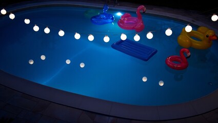 Colorful Inflatable Pool Toys Floating on Clear Blue Water, AI Generated