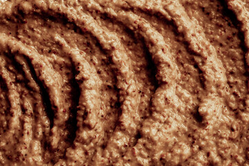 Chocolate ice cream with nuts and banana, texture. Chocolate smoothie cocktail close-up. Nut paste as a background.