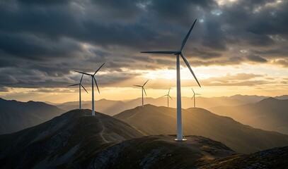 Wind turbines standing tall on mountain ridges at sunset under dramatic cloudy skies.