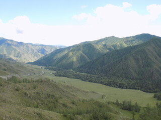 Fototapeta premium Altai Mountains - Majestic mountain landscape with rolling hills under a clear sky in a remote area during daylight
