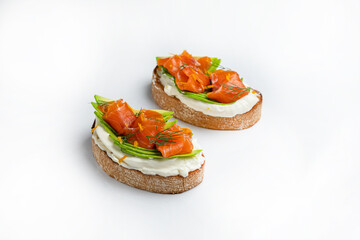 sandwiches with salmon and cheese, meat and tomatoes on a white background