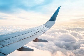 Obraz premium Airplane wing glides through the sky with golden light and endless landscapes far beneath