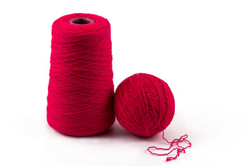 Skein and ball of red woolen thread on white background
