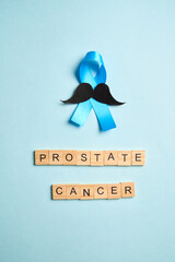 Blue ribbon with mustache supporting prostate cancer awareness month and men's health