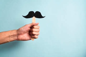 Male Hand holding mustache supporting prostate cancer awareness month and men's health
