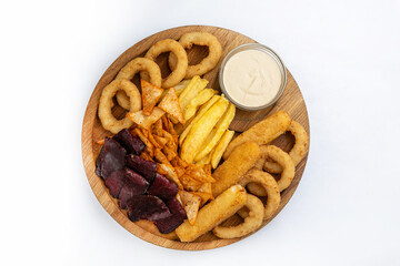 Snacks for beer on a wooden plate on a white background.