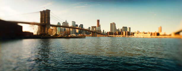 Panoramic view of suspension bridge with a city in the background, Brooklyn Bridge, Manhattan, New York City, New York State, USA.