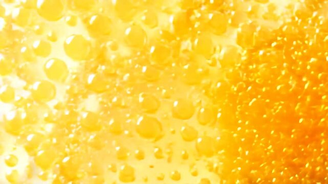 Close-up of yellow beverage bubbles on a light background, creating a refreshing look.