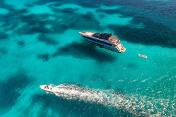 Naklejka premium Aerial view of beautiful luxury yacht and speed boat in blue sea in summer. Sardinia, Italy. Top drone view of boat, sea bay, transparent azure water. Travel. Tropical colorful landscape. Yachting