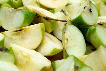 a detailed close-up shows many slices of fresh, light green apples with visible seeds and cores