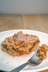 An apple crumble on a plate with a fork