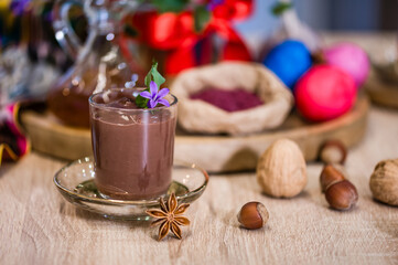 Traditional Azerbaijan sweet cuisine of holiday Nowruz: national dessert called Sumalak, assortment of nuts and colored egg. Selective focus.
