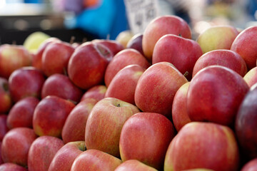 Red apples on a market stall. Yummy pile of apples in a market stall. Close-up