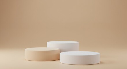 Three round podiums in varying heights and neutral colors against a beige background in a studio shot