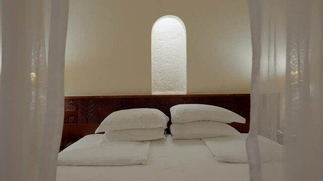 Pull away from king-size bed in luxury hotel suite in Africa with mosquito net. Canopy for insect protection and bug bite prevention in fancy suite in expensive resort for safari vacation trip