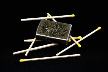 lighter and matches on a black background