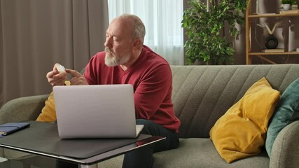 Senior Man Checking Weekly Pill Organizer at Home