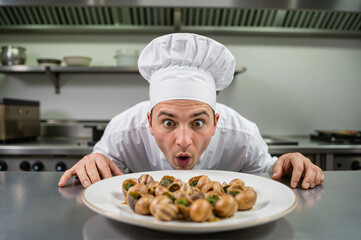 Funny Chef Exaggerating a Shocked Reaction to a Plate of Escargots in Restaurant Kitchen