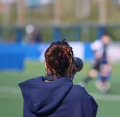 A photographer at a football field or sporting event	
