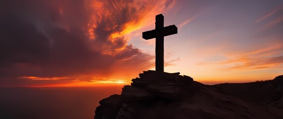 Old wooden cross mounted on rugged cliffside silhouetted by brilliant sky during fiery sunset colors