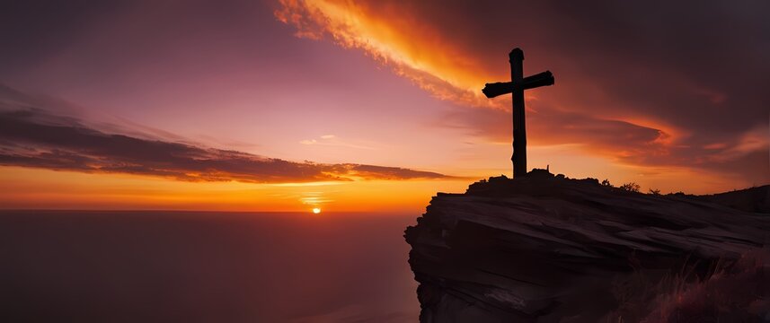 Old wooden cross mounted on rugged cliffside silhouetted by brilliant sky during fiery sunset colors