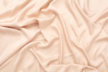Beige silk fabric texture as background, top view