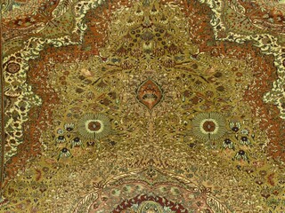 Intricate persian rug featuring ornate floral motifs, displaying rich colors and complex weaving techniques of classic oriental carpet craftsmanship
