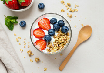 Healthy Yogurt Parfait with Granola and Fresh Berrie flat lay
