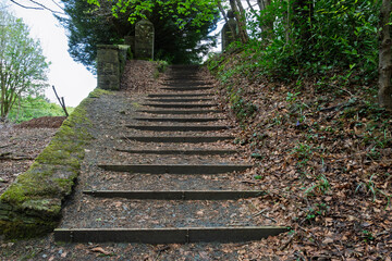 A staircase with a wooden railing and a stone pillar