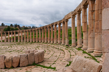 A large stone archway with columns and a stone circle in the middle
