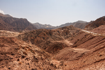 A desert landscape with a mountain in the background