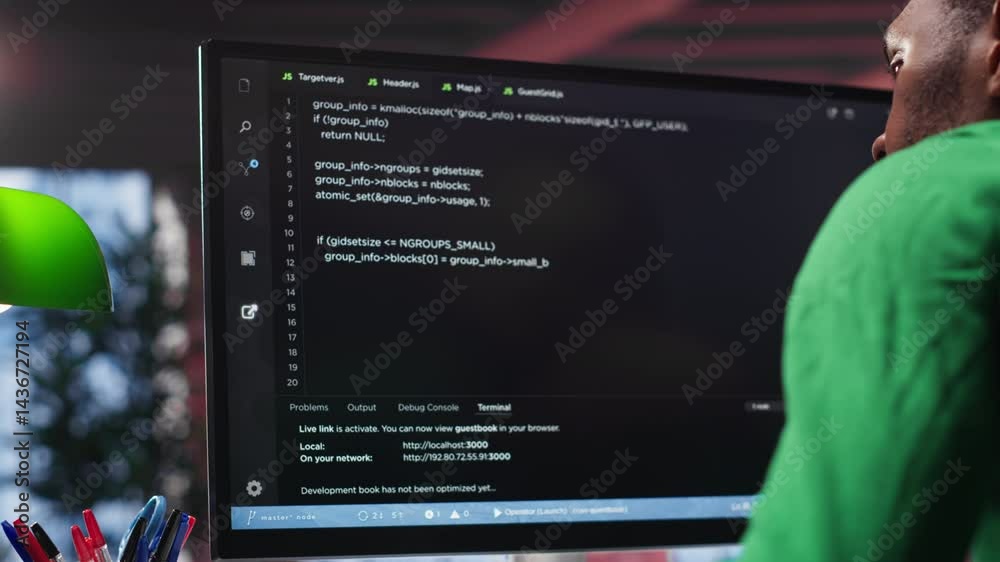 Fototapete Black system administrator creating a software with programming language. Professional engineer focuses on app development, debugging, encryption and security at home. Camera A.
