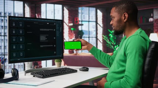 Young man using AI chatbot to generate real time responses next to mockup display, power of artificial intelligence. Smart automation simplifying online communication and problem solving. Camera B.