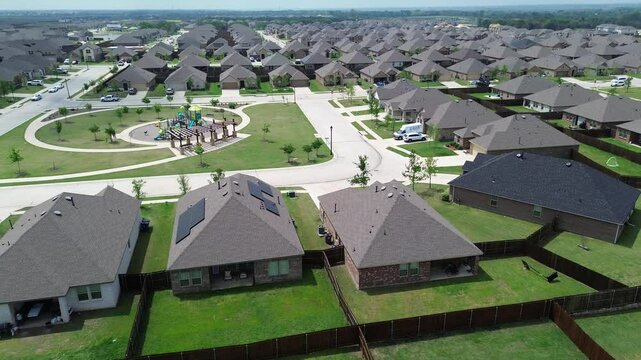 Flyover new construction two story houses with solar roofing and children playground park in Princeton suburbs Dallas metroplex, upscale suburban homes in fast growing Collin County, North Texas