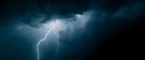 lightning bolt striking through a dark cloudy sky