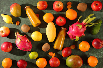 Banner with tropical exotic fruits and juice. Dragon fruit, pitaya, mango, kiwi, avacado, apples, citrus fruits and dried apricots. Advertising card for a market or store. Healthy vegan