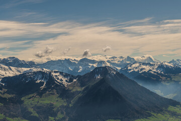 Stunning view of snow-capped mountains under a clear sky in the alpine region during late afternoon light