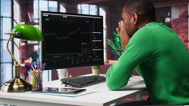 Upset broker distraught after losing money in cryptocurrency, falling for investment scam due to rug pull. Unhappy worried guy in bankruptcy crisis, financial loss after risky trade. Camera B.