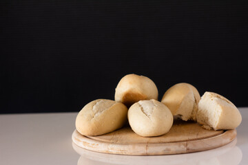 Freshly Baked Bread Rolls on a Wooden Cutting Board