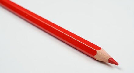 Red colored pencil close up on white surface ready for drawing