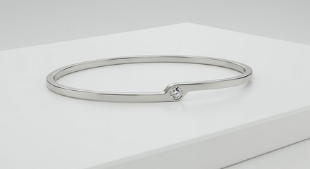Elegant Silver Bangle Bracelet with Diamond Accent on a White Surface