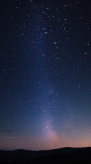 Fototapeta premium Stunning night sky filled with stars and the Milky Way, creating a serene cosmic landscape.