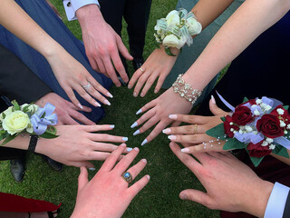 Hands of the newlyweds and their friends