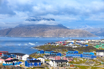 Panoramic view of Greenland capital Nuuk with colored houses located near fjords and icebergs.