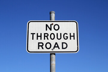 No Through Road sign against a clear blue sky background