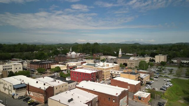 Aerial over downtown Lenoir North Carolina with churches and buildings