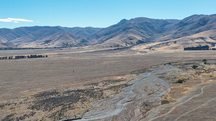 Remote rural arid desert like valley McKenzies Pass near Dog Kennel corner Tekapo