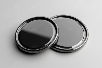 Monochromatic Black and Silver Lids on White Surface Creating a Striking Monochromatic Contrast in a Clean Studio Still Life