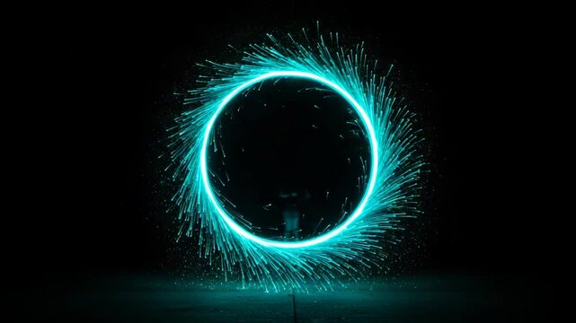 Sparkling teal light circle against a dark background  