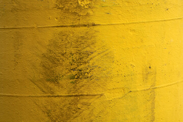 Yellow painted surface with black smudges abstract textured background